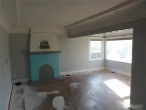 Living room with fireplace and dining area.