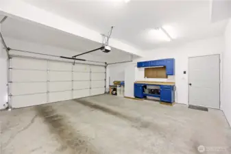 Garage walls are finished and painted with built-in workspace