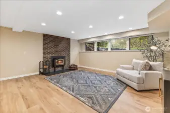 Lower level space with woodburning fireplace.