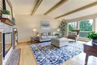 Vaulted ceilings and a dramatic wall of windows fill the living room with natural light, perfectly framing sweeping eastern territorial and mountain vistas.