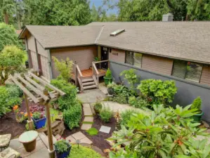 Remodeled to perfection while nestled in and surrounded by beautiful gardens, this lovely home offers a sanctuary of relaxation and tranquility. The front porch with new decking offers views of the amazing front terraced gardens with patio, trellis and charming fountain.