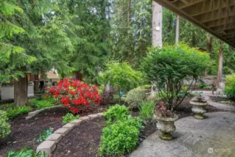 Private and lovely back gardens and patio are filled with stunning plants, flower pots and majestic trees.