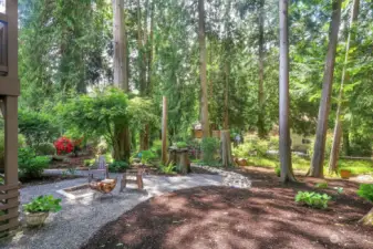 The backyard offers a fire pit and lots of garden space. The kids growing up would put in zip lines and rope swings between the trees. There is also a storage shed and potting table for all of your tools.
