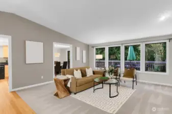 Vaulted and spacious, the formal living room offers a wall of windows for lovely green scape views.