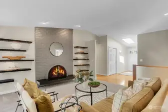 With a choice of gas logs or wood, the fireplace warms this space with floor to ceiling brick and a hearth made of "Absolute Black" honed granite. The floating display shelves all have architectural spot lights.