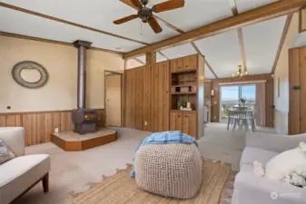 Looking from the living room across the dining room with the bay and island views beyond.