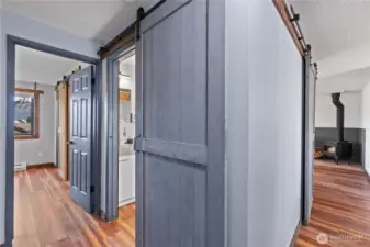 This hallway barn door provides privacy for the full bath without taking up space that a swinging door would require.