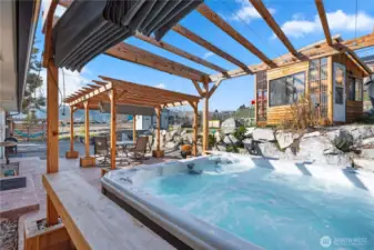 Here we are on the patio level. The hot tub, included in the sale, has its own arbor with sliding cover.  Note the greenhouse on the upper terrace.