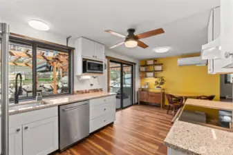 This bright and airy kitchen is perfectly set up for indoor/outdoor dining and entertaining. (The big sliding window by the sink makes a convenient pass through!)