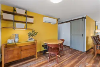 The owners don't need a large dining table, but there is space for one.  Notice the barn door in the background ...
