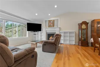 Living room w/brand new carpet, gas fireplace w/custom mantel & book shelf surrounding