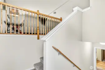 A bright split-level entry welcomes guests with soaring ceilings and clean lines. New interior paint and carpet provide a crisp first impression, while the open railing previews the upper great-room and the flexible lower level.