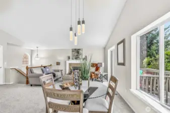 From the dining area, the full great-room comes into view—light-filled, vaulted, and designed for easy circulation. Proximity to the deck encourages al-fresco dining and relaxed evenings.
