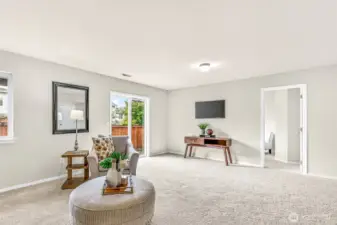 Lower-level living extends toward the backyard through the sliding door—perfect for casual entertaining.