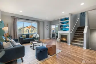 Open concept main living full of light and hardwood flooring.