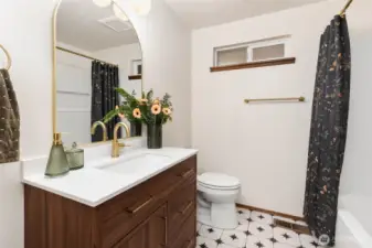 The main floor full bathroom was fully remodeled in 2025 and features gold fixtures.