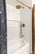 This main floor full bathroom is equipped with a luxurious rain shower.