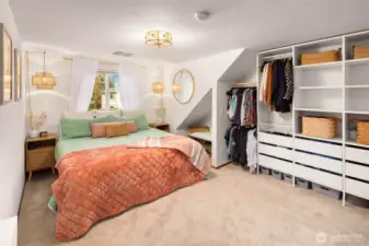 The primary bedroom features a large built in closet space as well as an additional deep closet area.