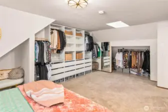 The additional closet space in the primary bedroom is extremely deep and fitted with lighting for optimal visibility.