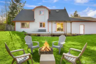 Exterior shot of the back of the home, including the back yard.