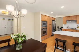 The breakfast bar extends into a casual dining nook.