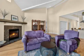 Great room with vaulted ceilings and fireplace with slate surround.