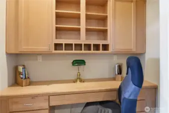 The workstation is enclosed with doors and accessed from the kitchen.