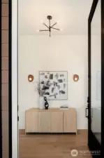 A dramatic 10-foot entry door welcomes you into the home, setting the stage for grand, yet warm, modern living.