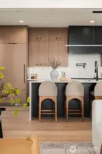 Full suite of professional Thermador appliances, 72" paneled refrigeration, dedicated pot filler, and walk-in pantry with room for a second refrigerator.