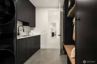 Direct access to mudroom with built-in benches and storage, keeping life organized and clutter-free.