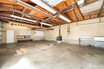 3 Car DETATCHED SHOP/ GARAGE   3 - 9’ Tall garage doors / Opener   10‘ Ceiling height, plus rafter storage  12’ x 10’ loft storage shelf with ladder