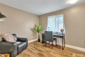This is the other secondary bedroom. It is freshly painted, vinyl and vinyl plank flooring.