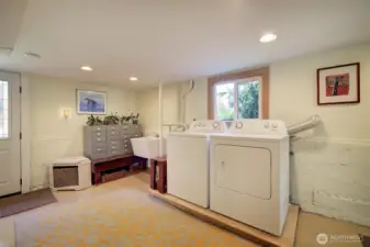 Spacious laundry area. Door to left leads out to the garden. This lower level could also be converted into another unit as it has two separate entrances.