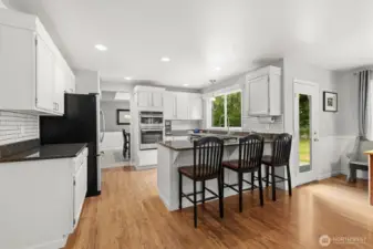 Spacious kitchen with granite countertops and eating bar.