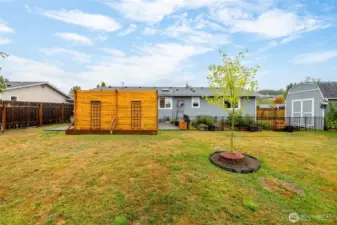 Back of the home and privacy wall. You can see the 10x10 barn shed with storage loft