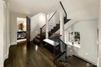 The second floor landing extends to a primary suite on the west side and two bedrooms with a shared hall bathroom to the east.