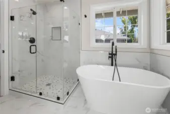 Freestanding soaker tub with fully tiled shower