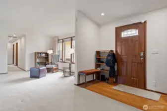Welcoming entry with real hardwood floors opens to the living room.