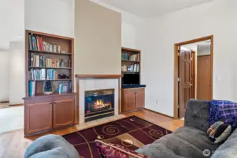 The family room with gas fireplace, built in book shelves, cabinets, and gorgeous hardwoods.