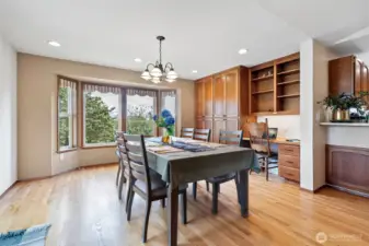 This breakfast nook may easily be able to accomodate an 8 to 10 seating table and just look at those gorgeous built ins and all that storage and work space!