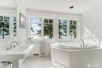 The primary bedroom’s 5-piece ensuite complete with a jetted tub, two sinks and shower.