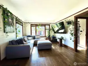 Livingroom, showcasing elegant coved ceilings and intricate custom millwork details with large windows, providing great natural lighting.