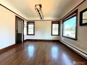 Dining room with coved ceilings, old custom millwork, and large windows offering lots of natural light.