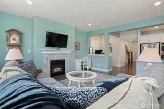 Main floor great room with a formal living room featuring a gas fireplace opens to the kitchen and dining room with sliding door to the back deck with Cascade Mountain views and southern exposure.