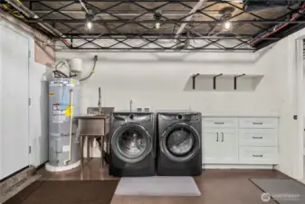 Laundry room with laundry shoot in basement with exterior access