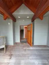 Covered porch, front door to the interior common entry.