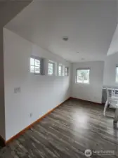 Vaulted ceiling and windows for natural light in the upper 2 bed/2 bath units. This shows area adjacent to full kitchen.