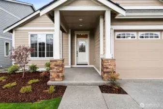Our Redwood one story floor plan has the perfect covered porch entry with stone accents to welcome you and your guests