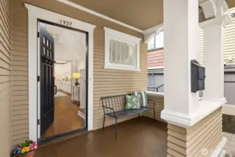 Welcoming covered porch greets you with timeless woodwork and period detailed windows.