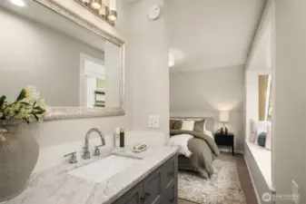 Vanity tucked away in the primary- leading into the full bathroom. This bedroom's own sink for privacy and convenience